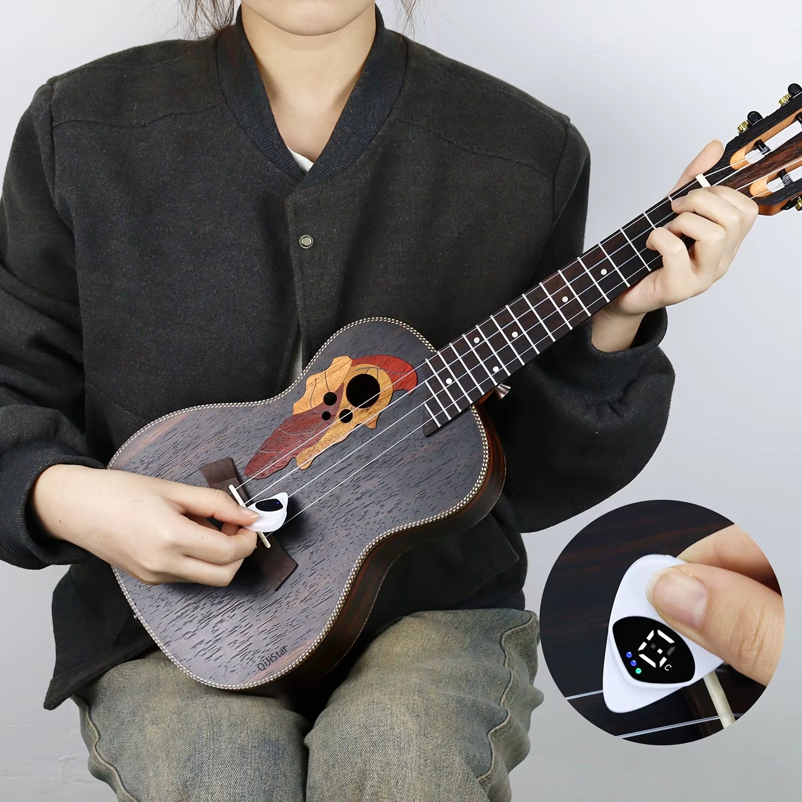 Magic Guitar Pick portable tuner displaying LED pitch indicators for perfect tuning.