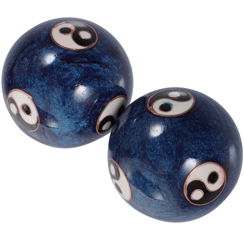 Two dark blue marbled Baoding balls with white, black, and copper-colored evil eye designs, shown on a plain white background.