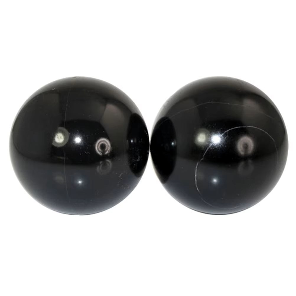 Two glossy black baoding balls, shown side-by-side on a plain white background.