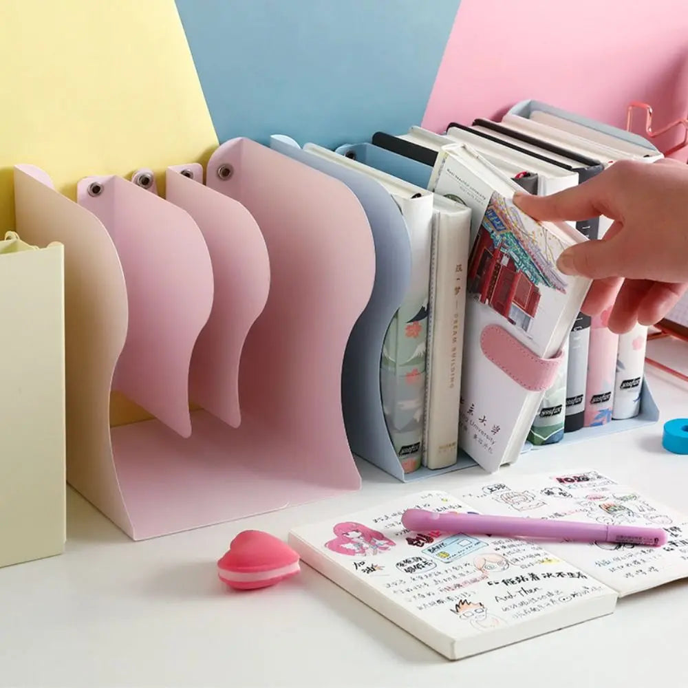 Colorful bookends holding books on a desk with stationery items.