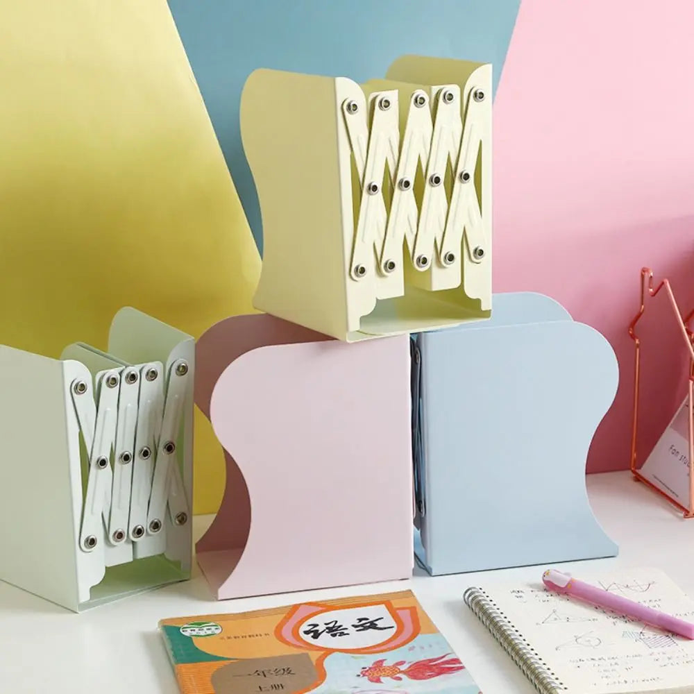 Colorful metal bookends on a desk with stationery items.