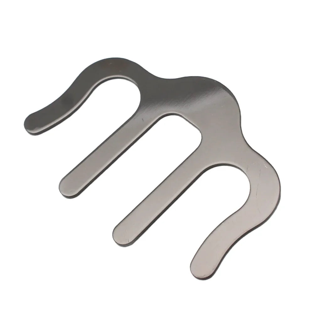 Metallic M-shaped sheet music clamp on a white background