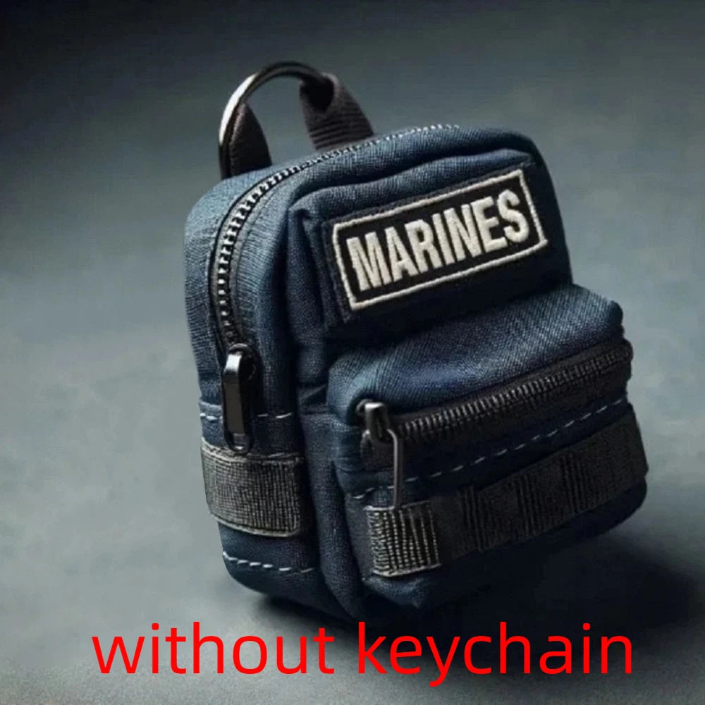 Small blue tactical pouch with 'MARINES' patch on a gray background