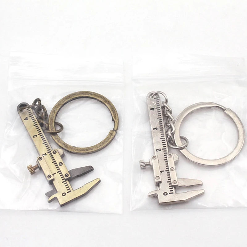 Two caliper-shaped keychains on a white background