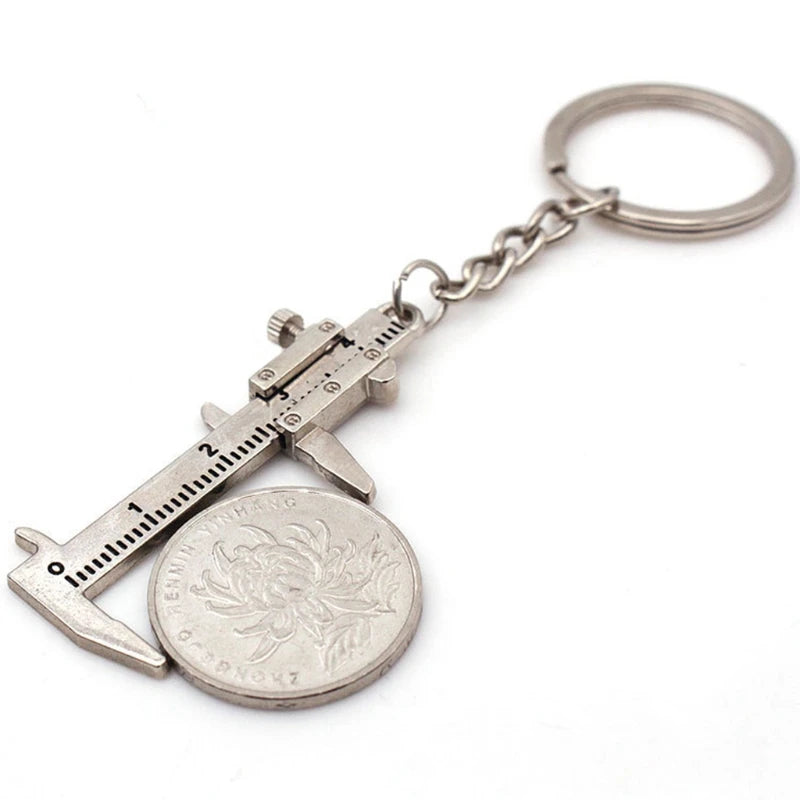 Keychain with caliper and coin on a white background