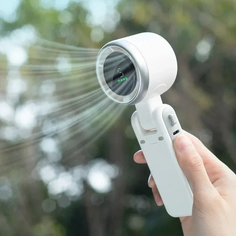 Handheld sprayer being used outdoors with a blurred natural background