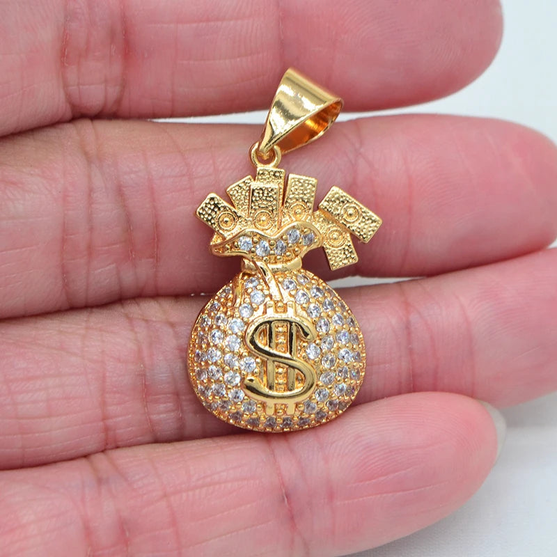 Gold pendant with a dollar sign design held between fingers