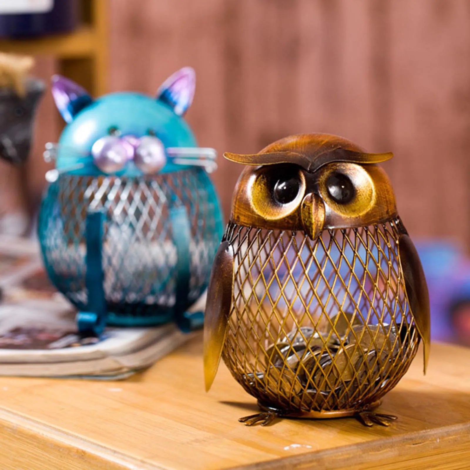 Decorative owl-shaped container with a blue cat-shaped container in the background.