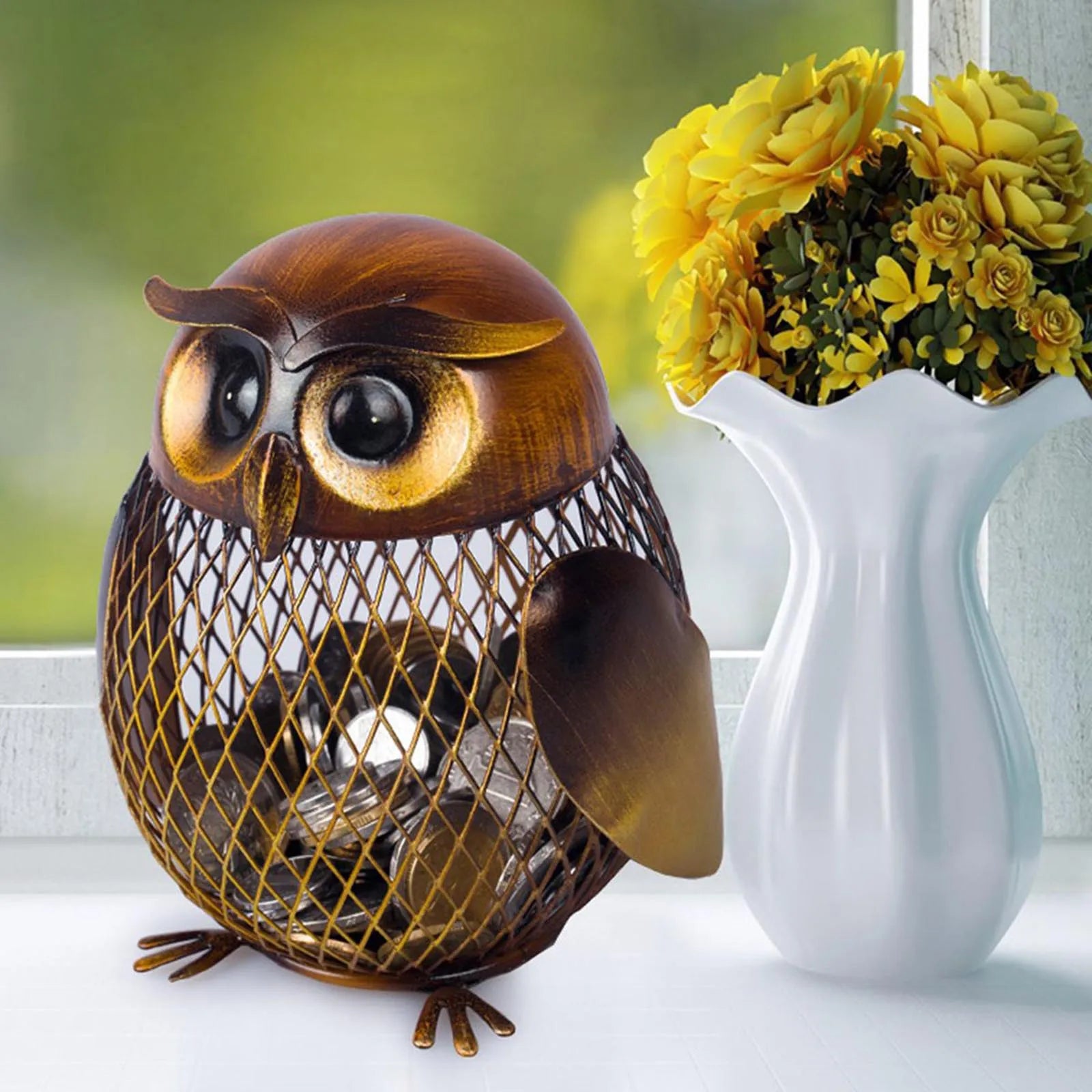Decorative owl-shaped lantern with a white pitcher and yellow flowers in the background