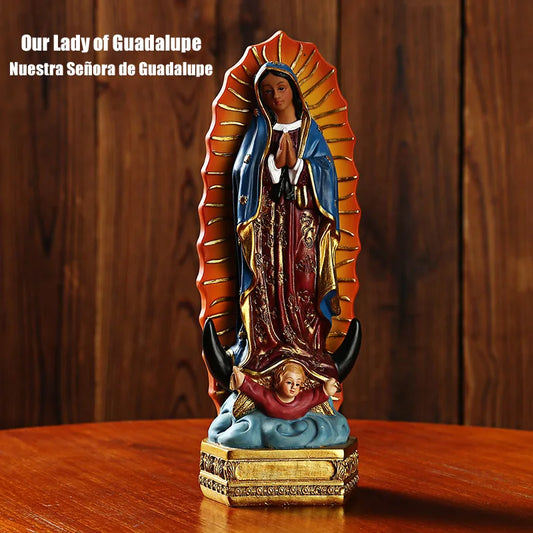 Statue of Our Lady of Guadalupe on a wooden surface with a wooden background