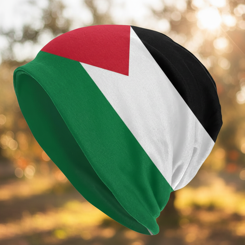 Beanie with Palestinian flag design against a blurred natural of olive and orange trees background