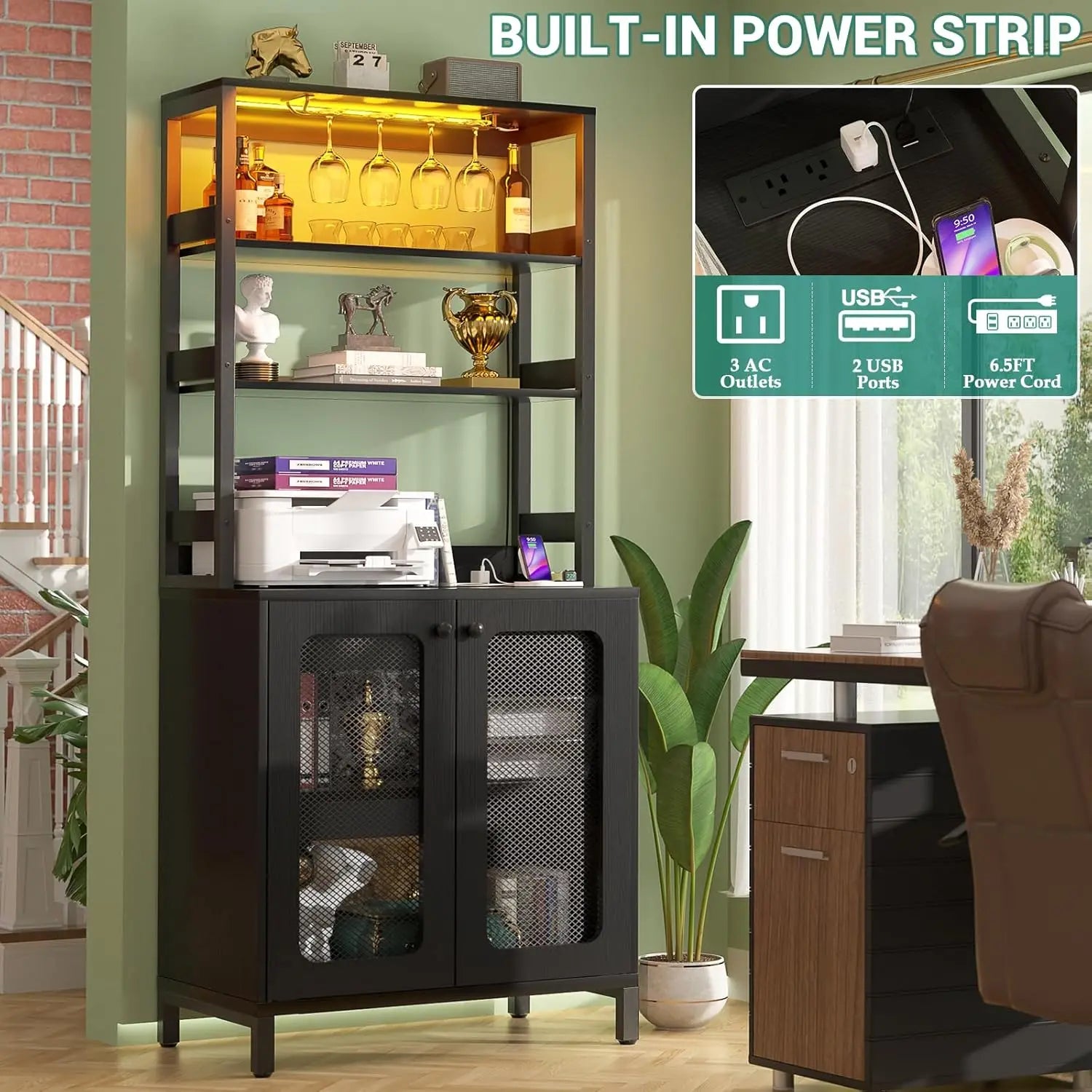 Black glass-fronted cabinet with shelves and a built-in power strip feature, surrounded by indoor plants and a desk.