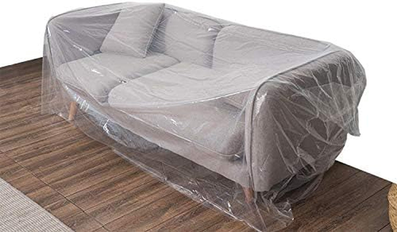 A gray sofa covered with a clear plastic furniture cover liner, placed on a wooden floor.