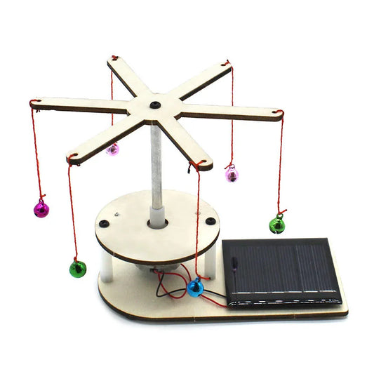 Solar-powered balance scale with colorful balls on a white background