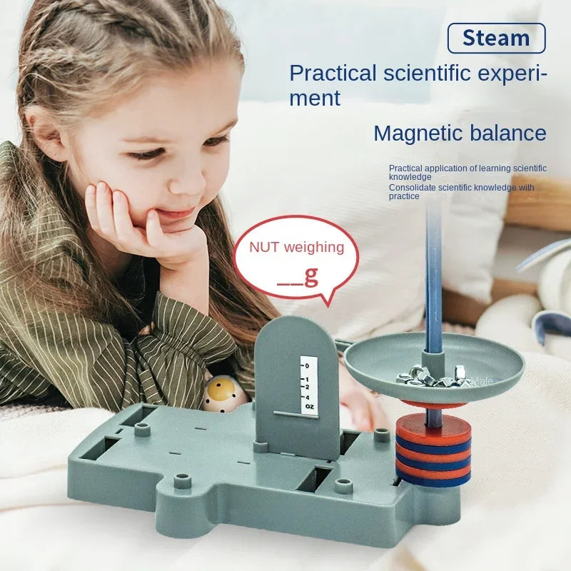 Child playing with a magnetic balance toy, labeled 'Steam Practical scientific experiment Magnetic balance'.