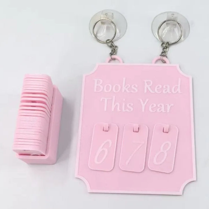 Pink bookshelf scoreboard with 'Books Read This Year' counter on a white background