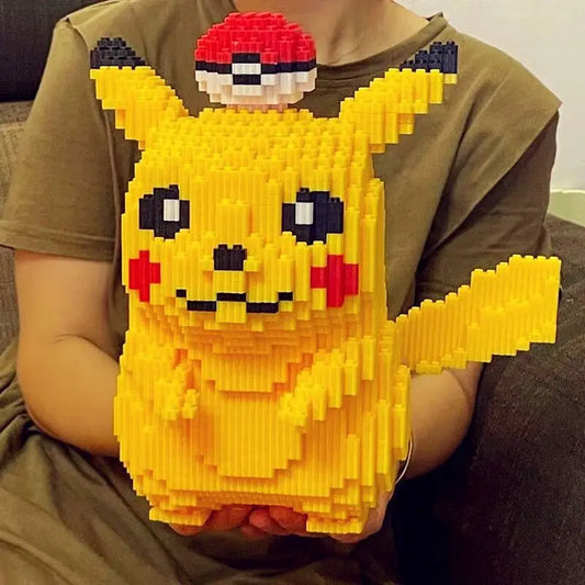 Person holding a large yellow Pikachu figure made of interlocking bricks.