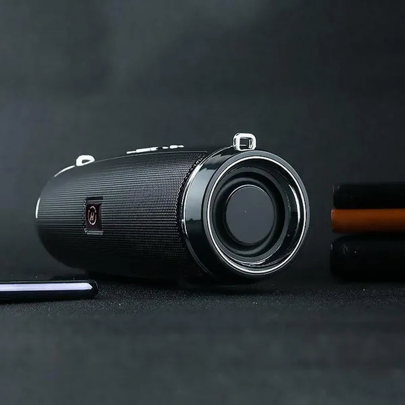 A black waterproof portable speaker advertised with various features such as Bluetooth 5.1 connectivity, 360-degree surround sound, and a double horn for enhanced bass.