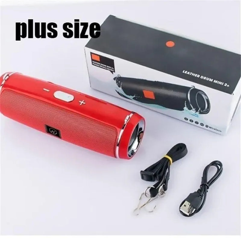 Red pill sized bluetooth speaker sat next to box and charging cables included with "plus size" text overlay above image.