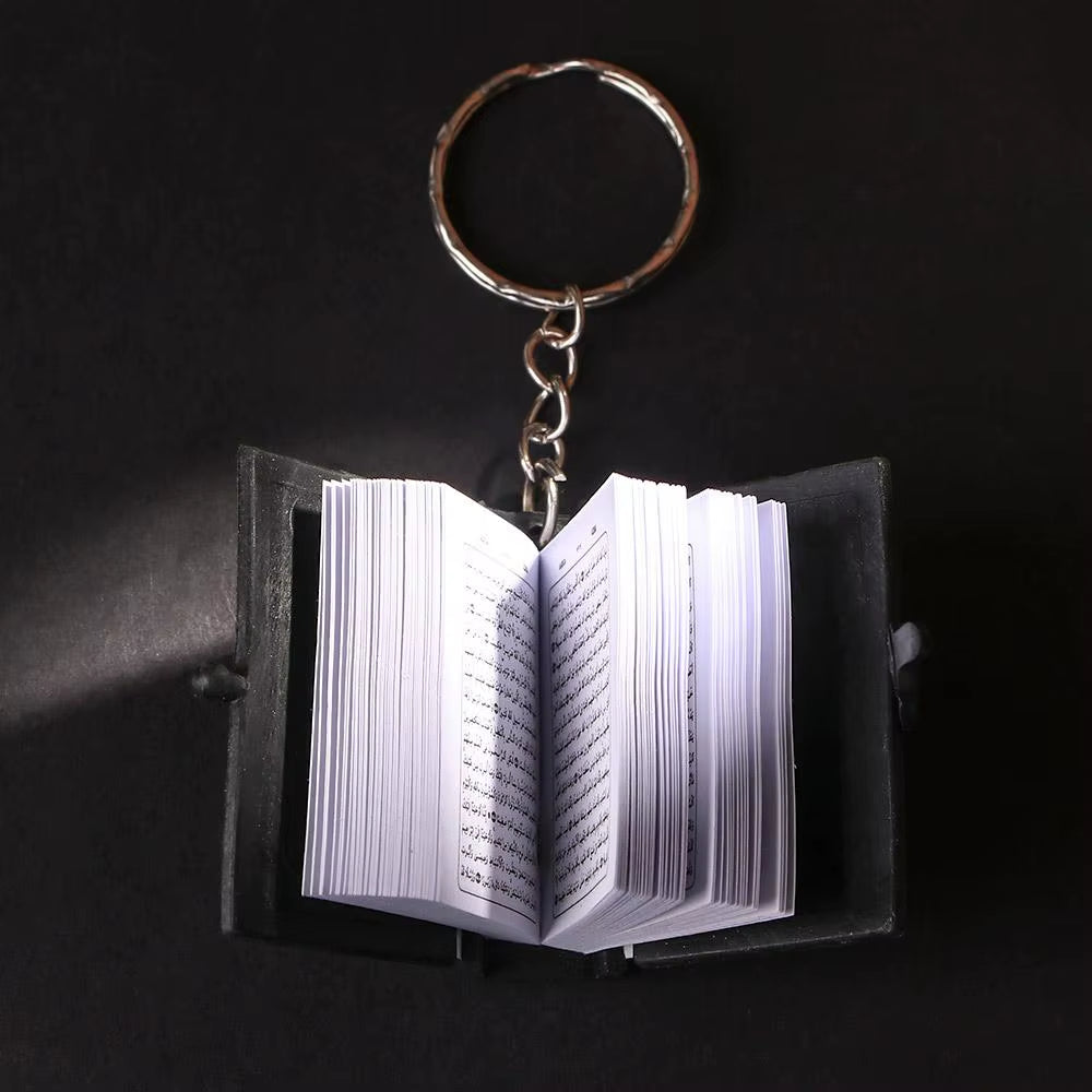 Keychain Qur’an laid open showing pages.