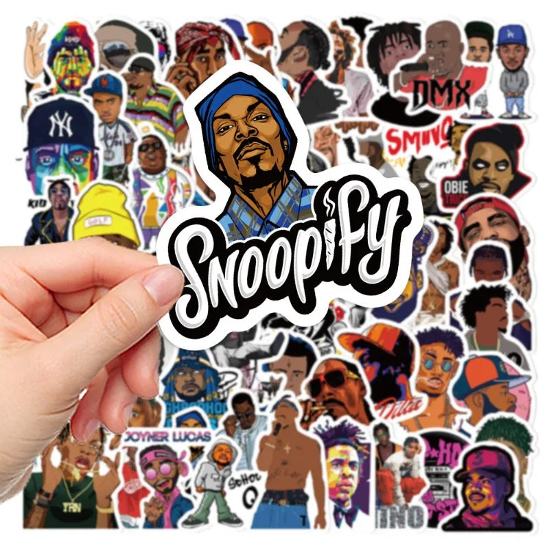 Rap and hip-hop sticker bundle in background and one sticker held close-up that reads 'Snoopify' and held in front of collection.