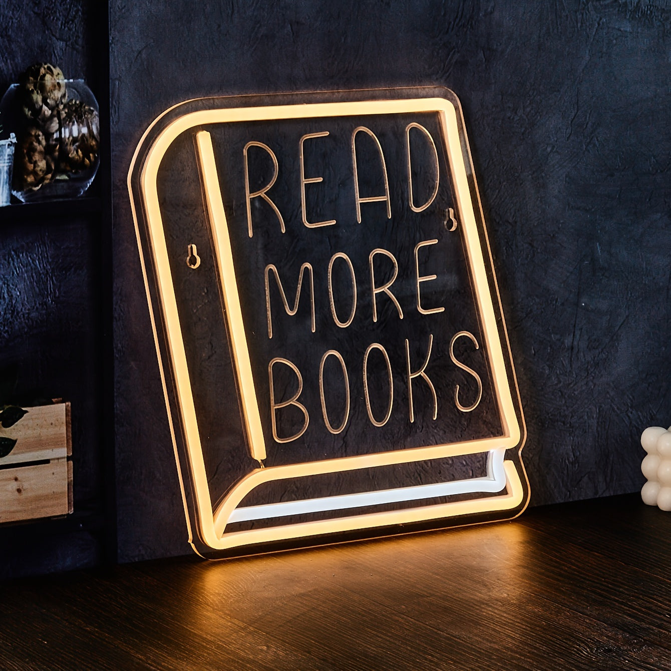 Decorative sign with 'Read More Books' text on a dark background