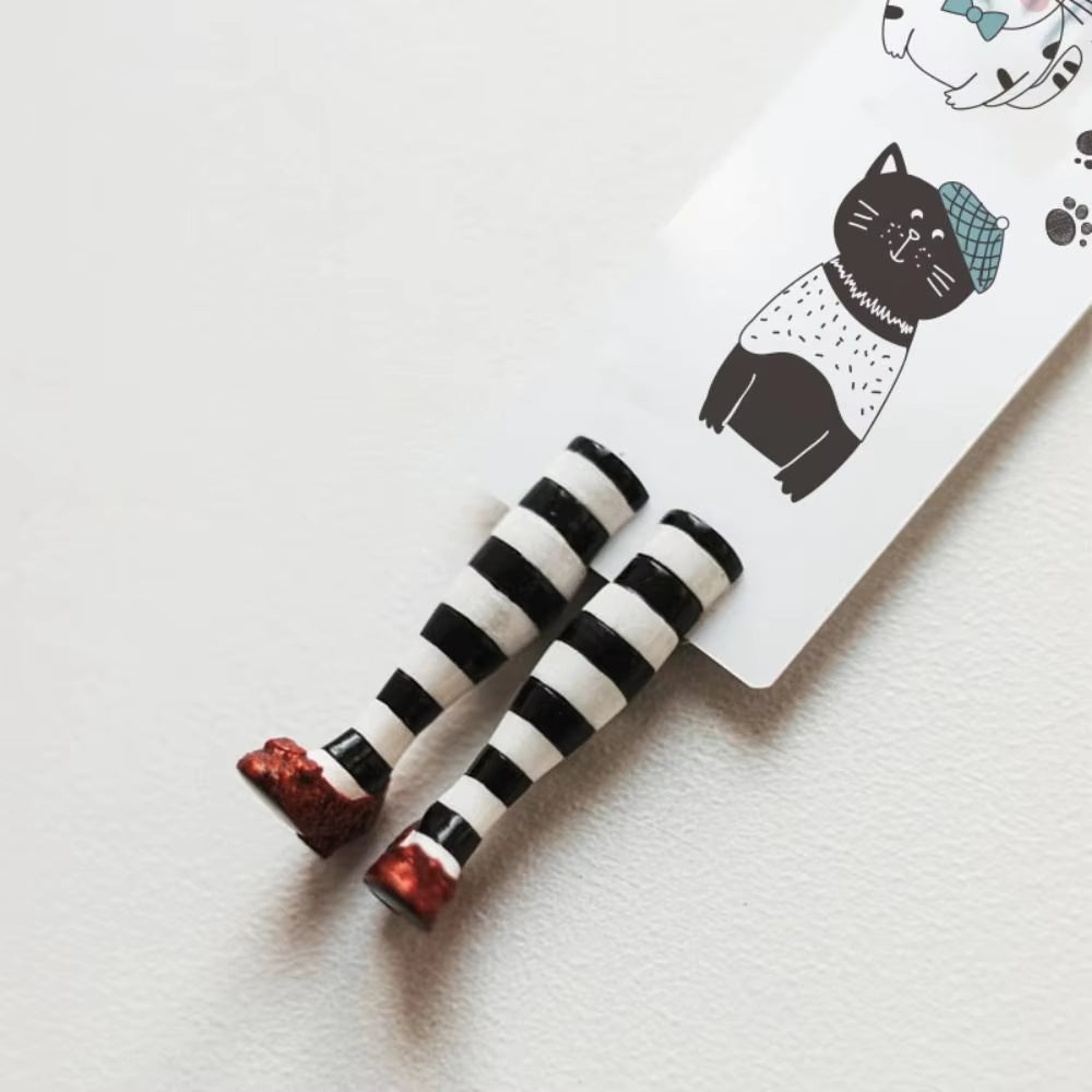 Red slippers bookmark attached to a paper insert with a beret wearing cat.
