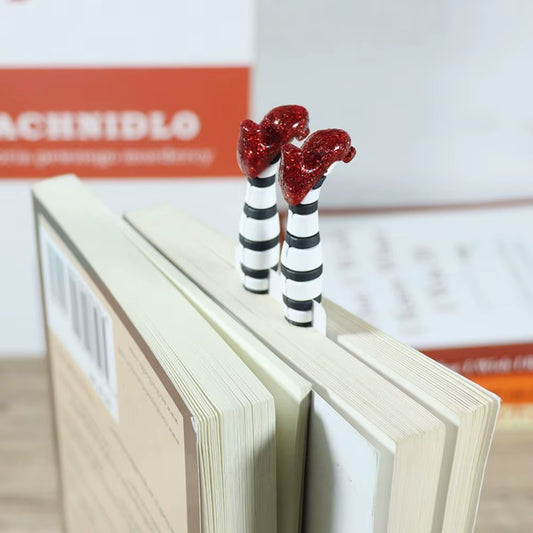 Red slippers bookmark shown upright in paperback book.