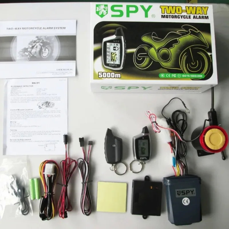 Spy two-way motorcycle alarm system packaging with components on a white background