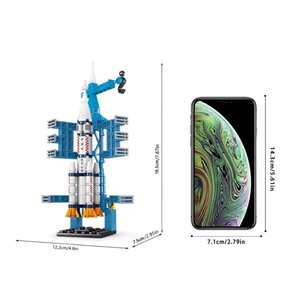 Model rocket set next to a smartphone for scale on a white background