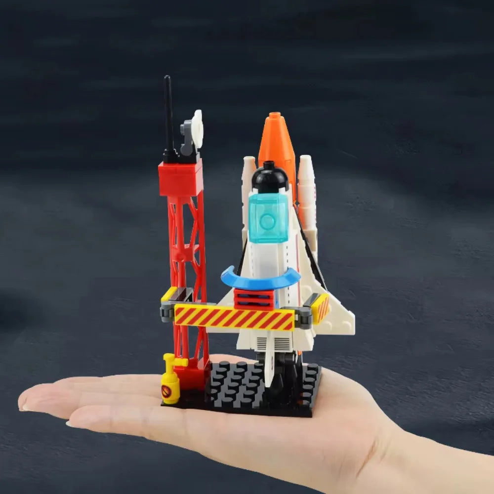 Toy rocket and launch pad set on a hand against a dark background