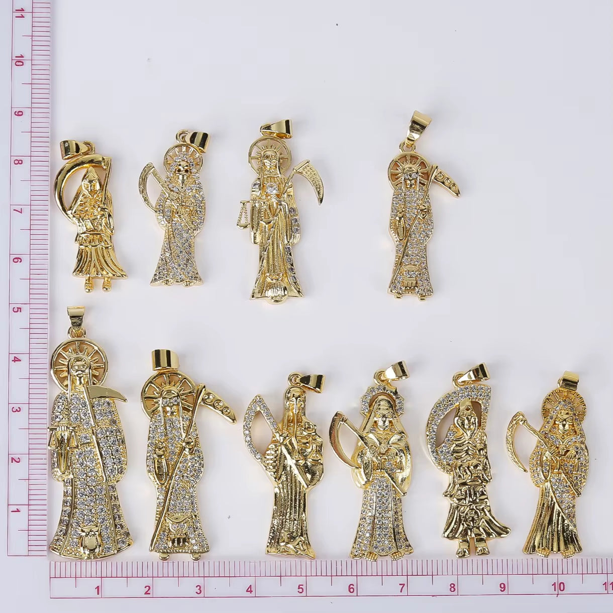 Image of various options from the Santa Muerte gold colored plated copper Bust-Down Piece & Chain Necklace by Protect Ya Neck Designer Jewelry Pieces design, over a white background.