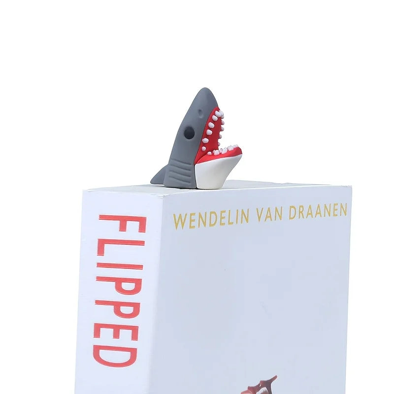 Shark-shaped bookend on an open book titled 'Flipped' by Wendelin Van Draanen