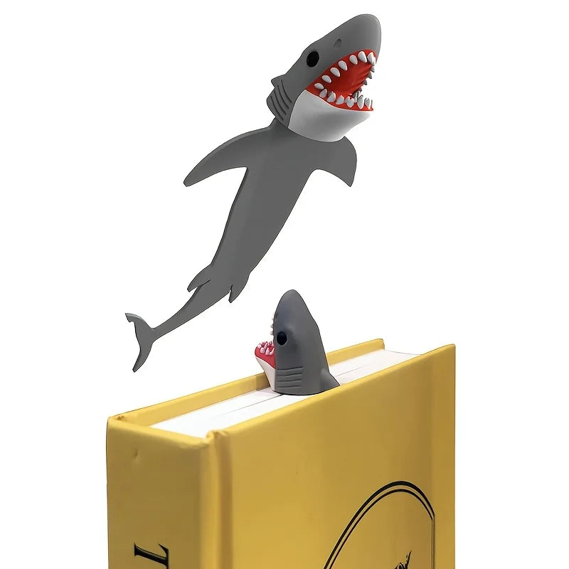 Shark bookmark emerging from a yellow book on a white background