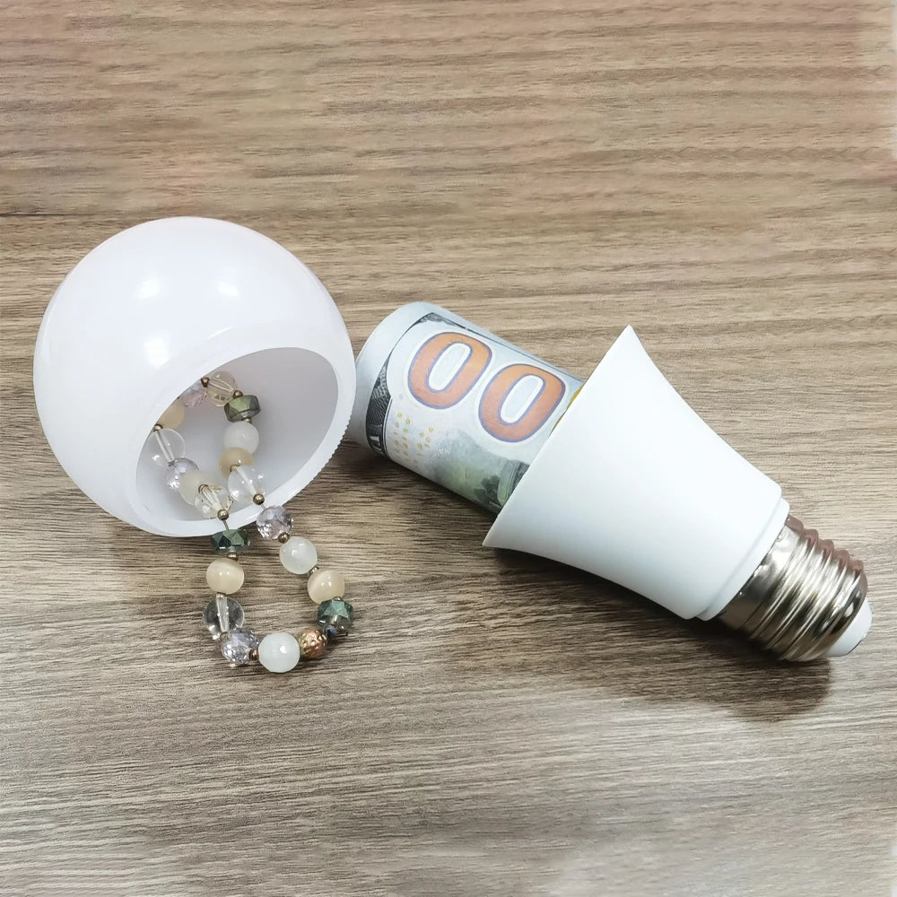 Light bulb with a roll of money and a bracelet on a wooden surface