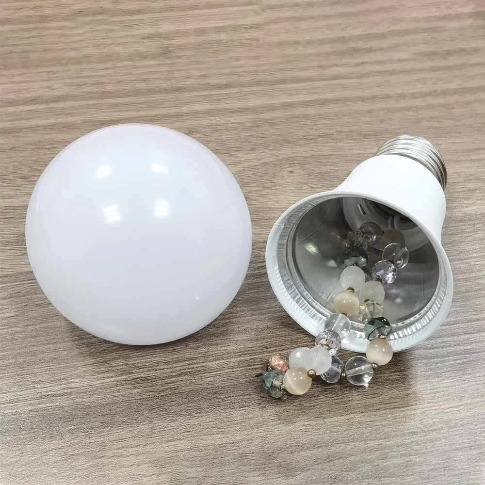 Light bulb with a decorative bead inside on a wooden surface