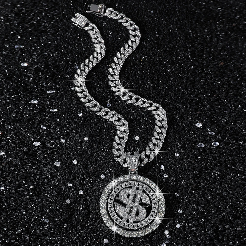 Silver cuban link chain necklace with a dollar sign pendant on a black background