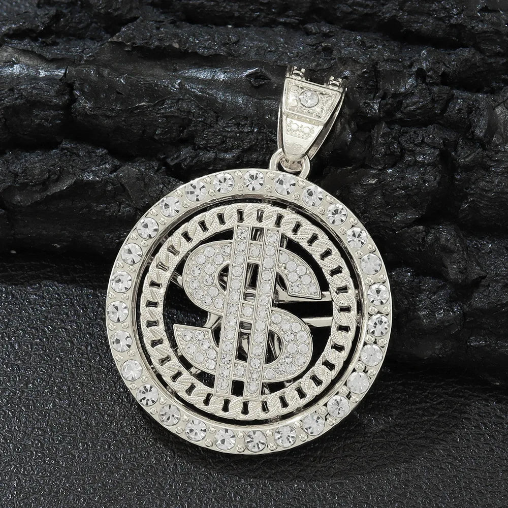 Silver dollar sign spinner pendant with clear stones on a dark stone background