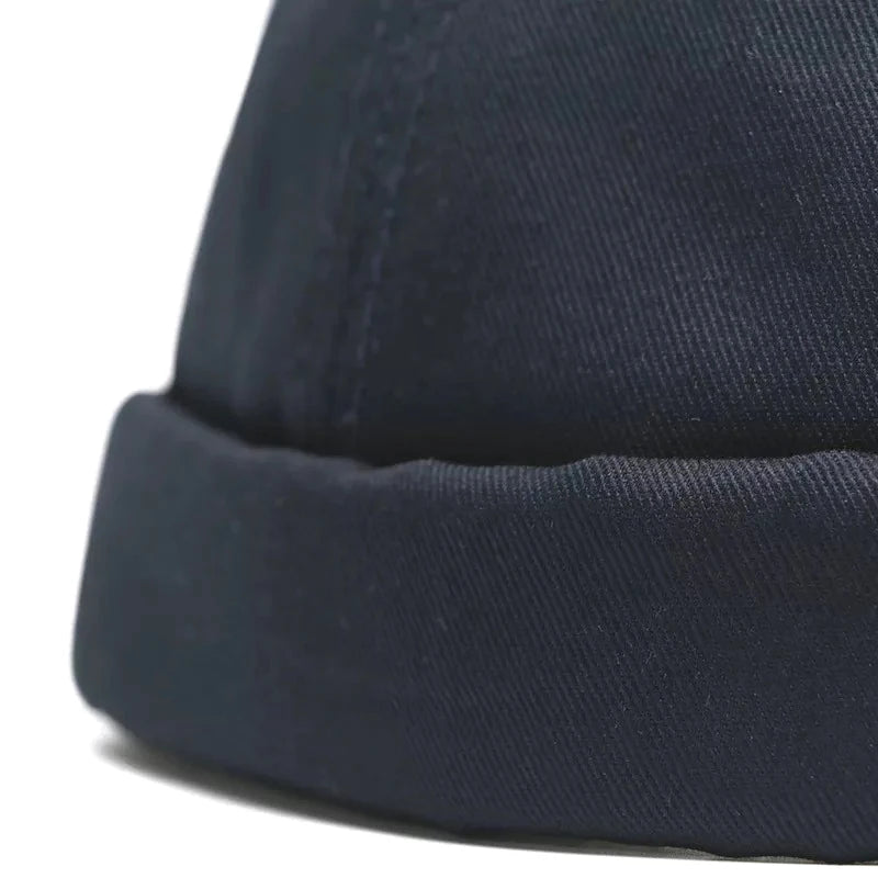 Close-up of a navy blue beanie with a blurred background