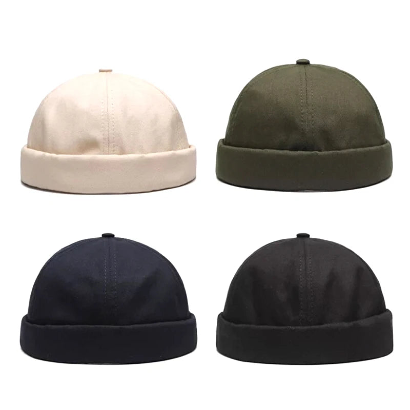 Four snapback beanie hats in beige, green, navy, and black on a white background