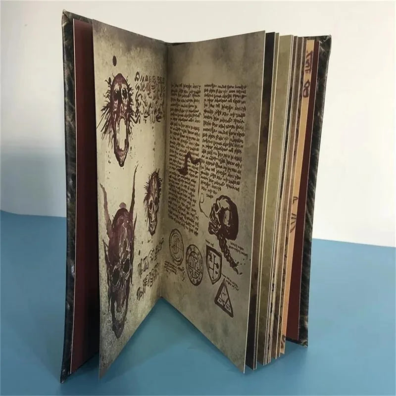 Open book with decorative text and illustrations on a blue surface