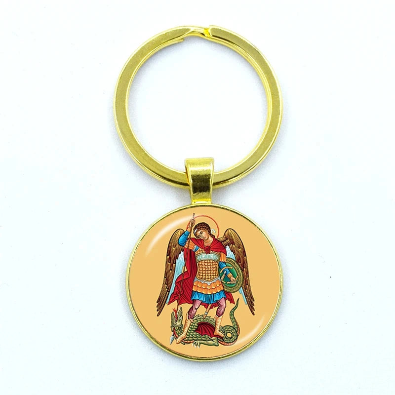 Gold keychain with an angelic design on a white background