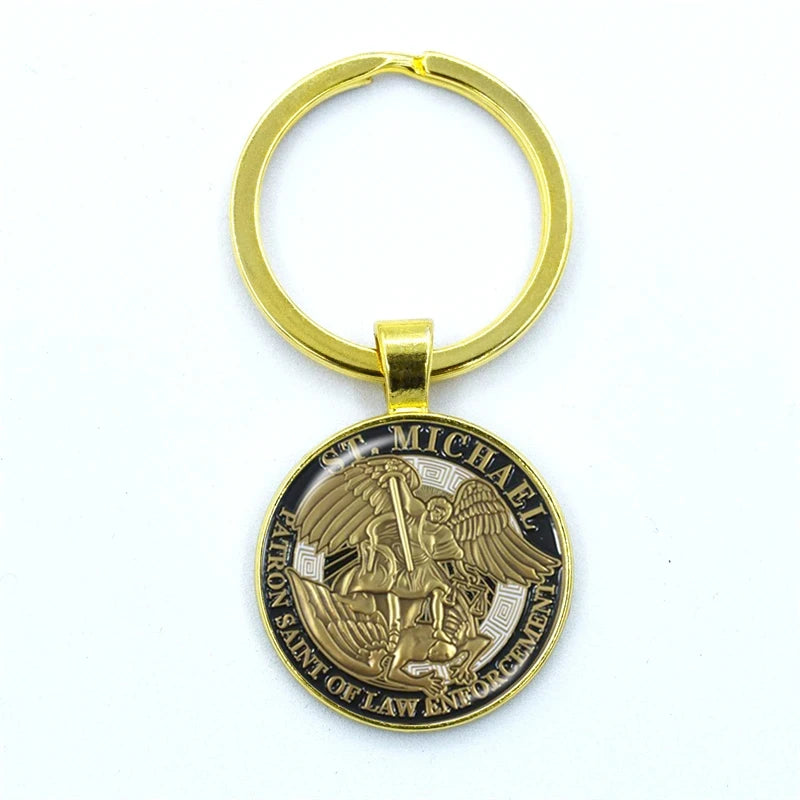 Gold and bronze keychain with a religious design on a white background
