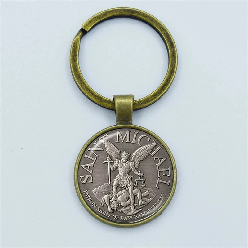 Bronze keychain with Saint Michael design on a light gray background