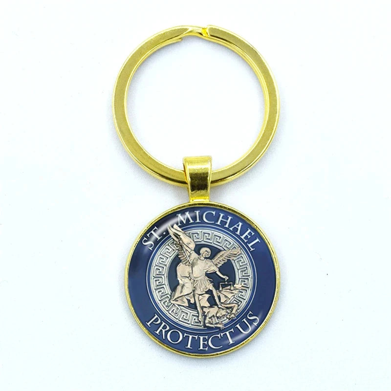 Gold keychain with a blue pendant featuring an angelic design on a white background