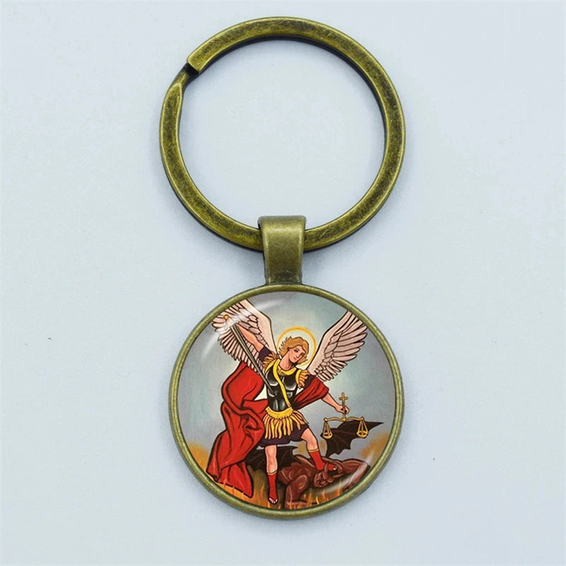 Keychain with archangel michael defeating satan and evil design on a light blue background