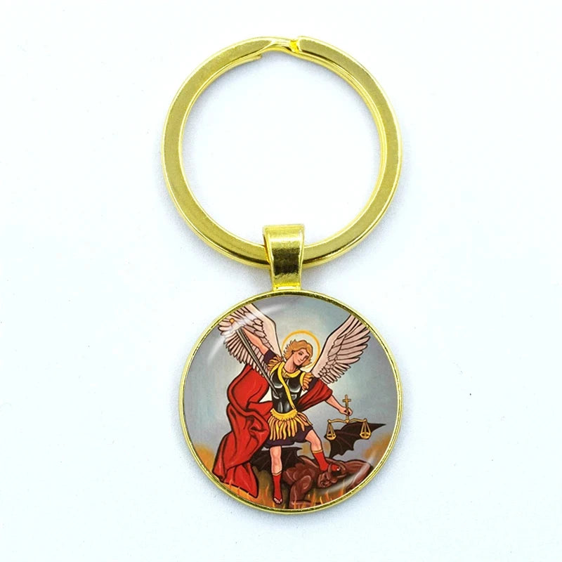 Gold keychain with an angelic figure design on a white background