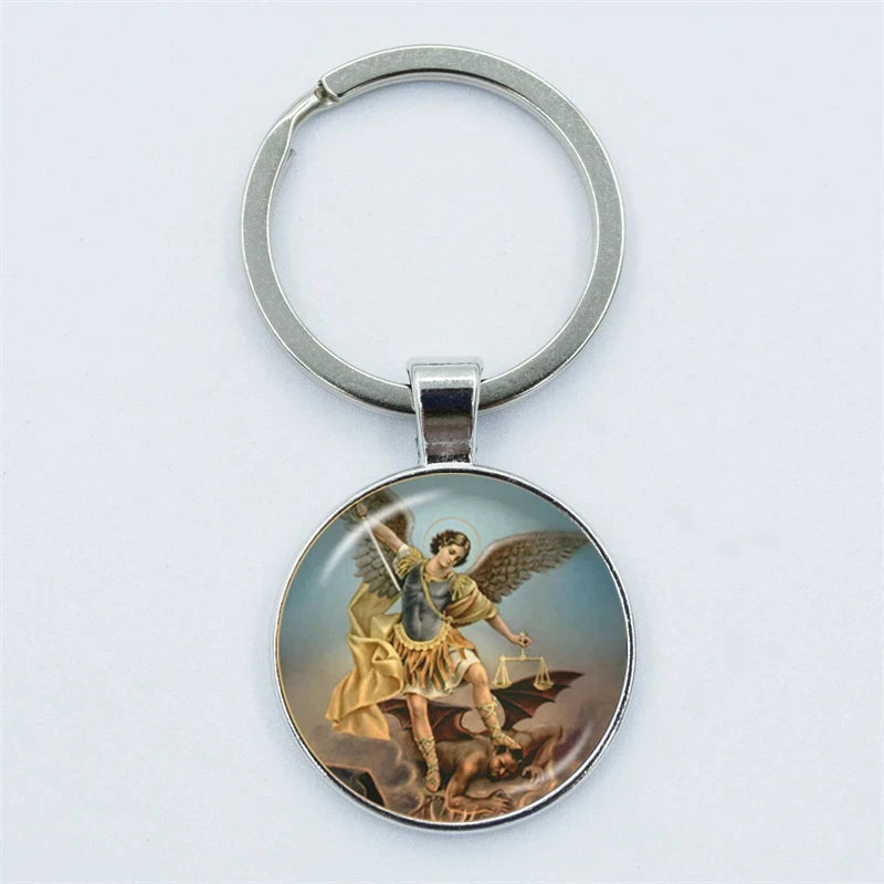 Keychain with an angel holding a scale on a light gray background