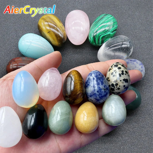 Hand holding a variety of colorful crystals and healing stones.
