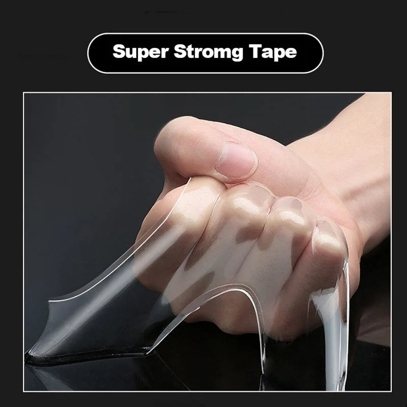 Hand holding a clear strip of super strong tape against a black background